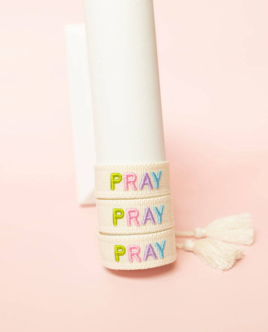 embroidered pray bracelet on bracelet stand