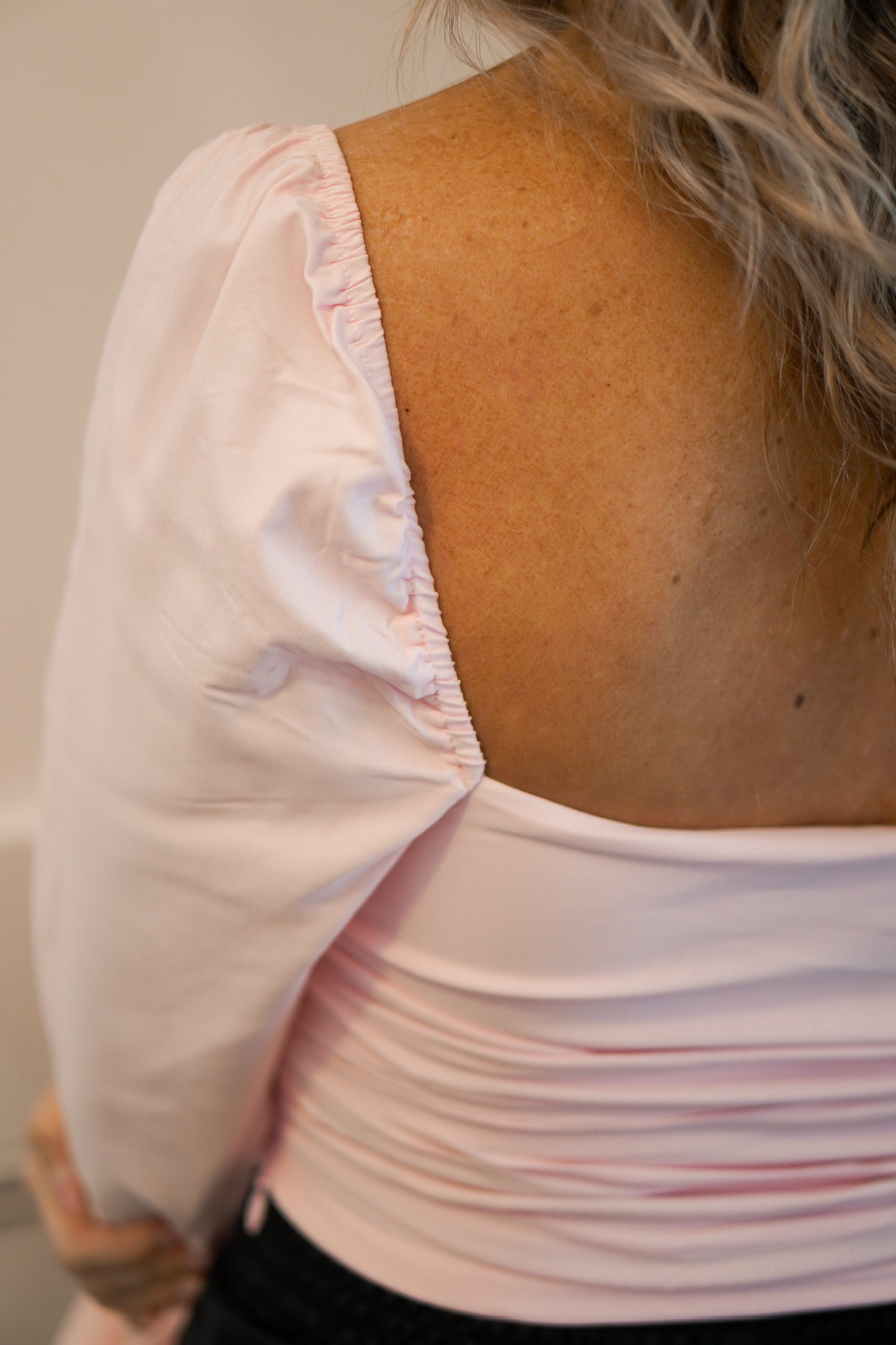 close up shot of the long sleeve light pink cropped shirt