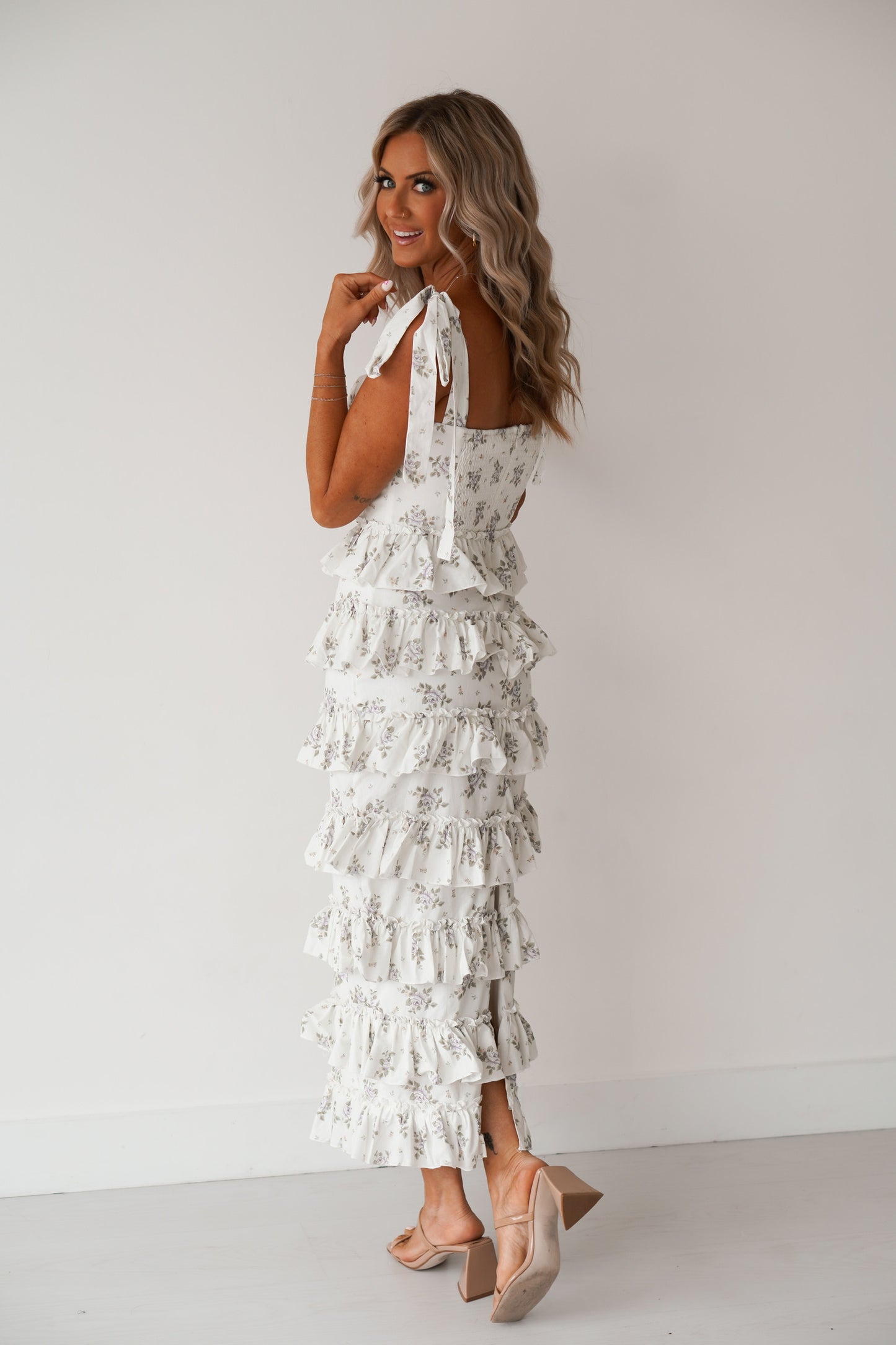 showing off the back of the floral tiered ruffled dress