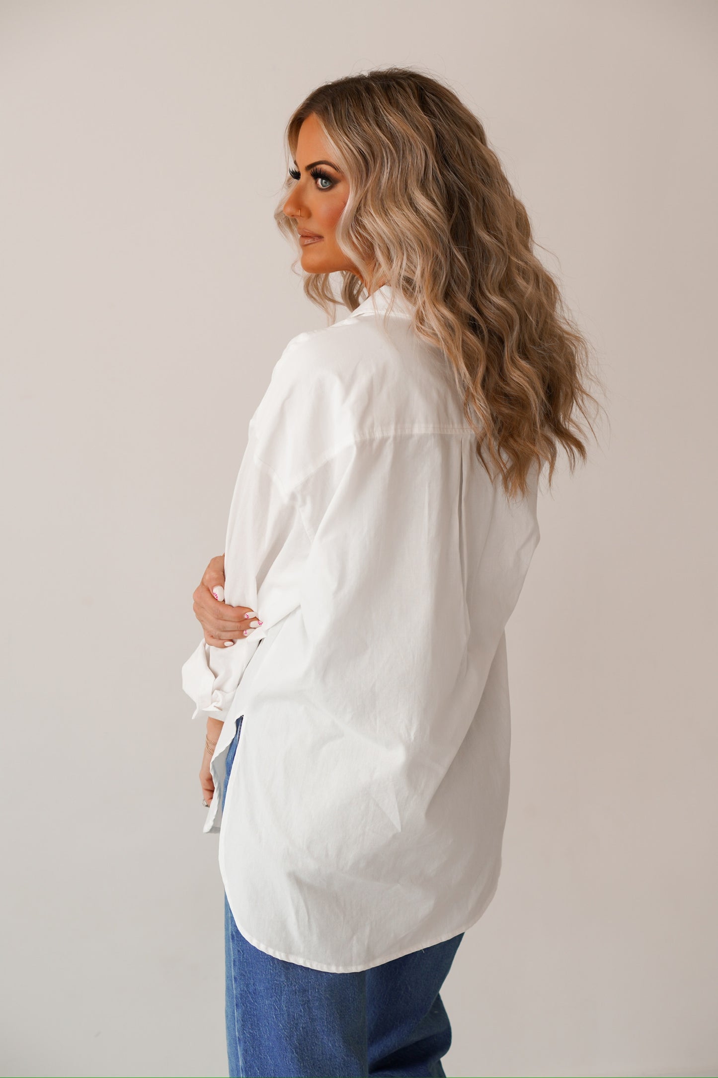 showing off the back of the white button up