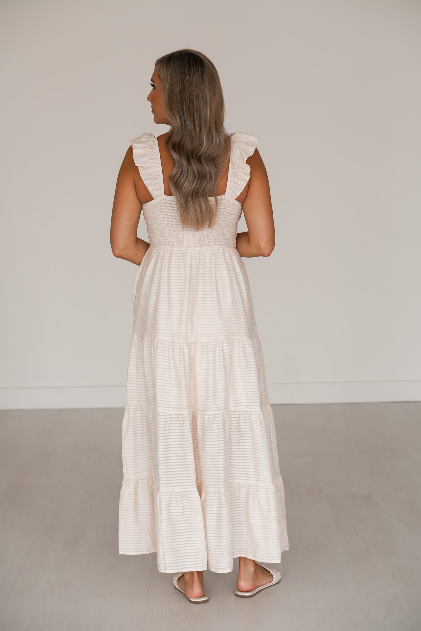 showing off the back of the dress that has smocking