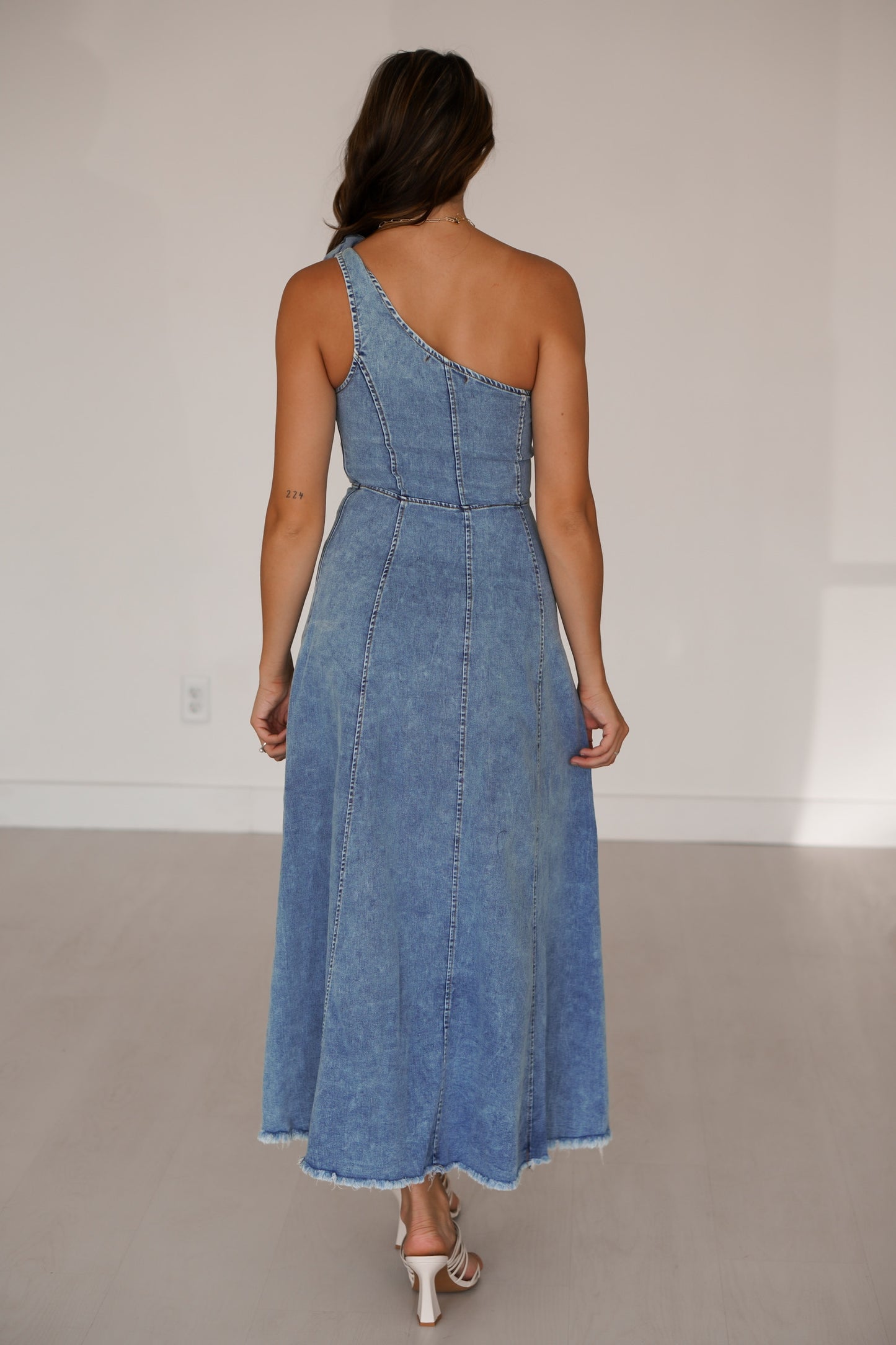 Showing off the back of the long denim dress