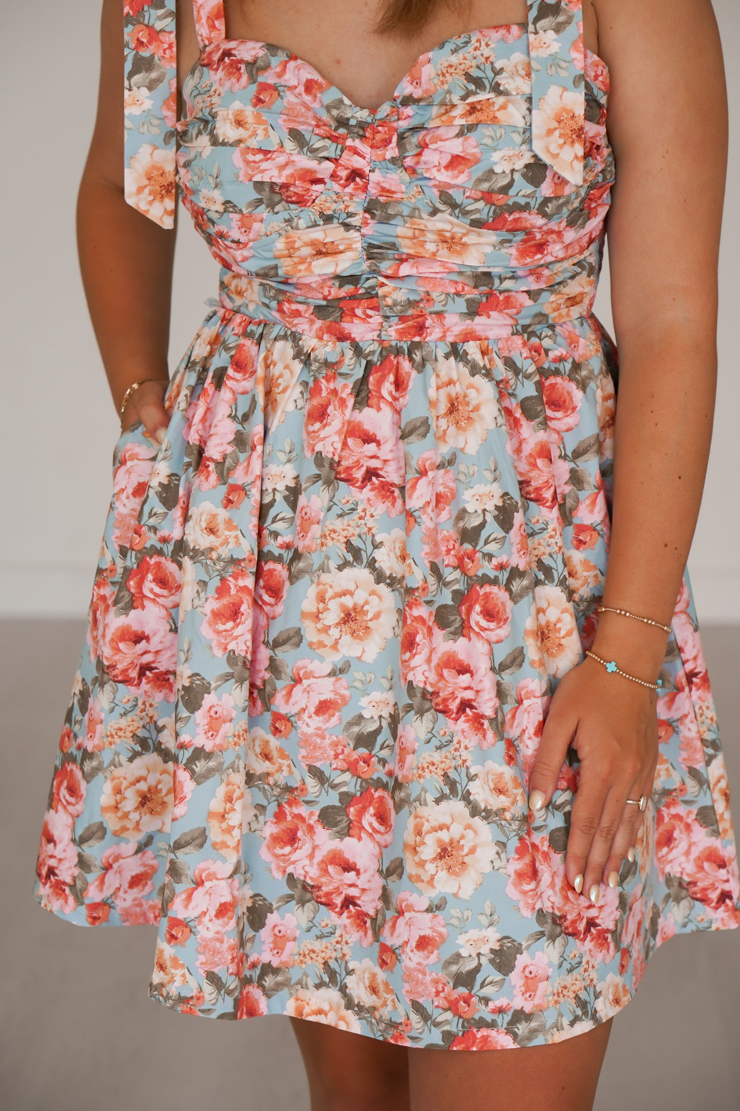 Showing an up close of the floral print and pockets 