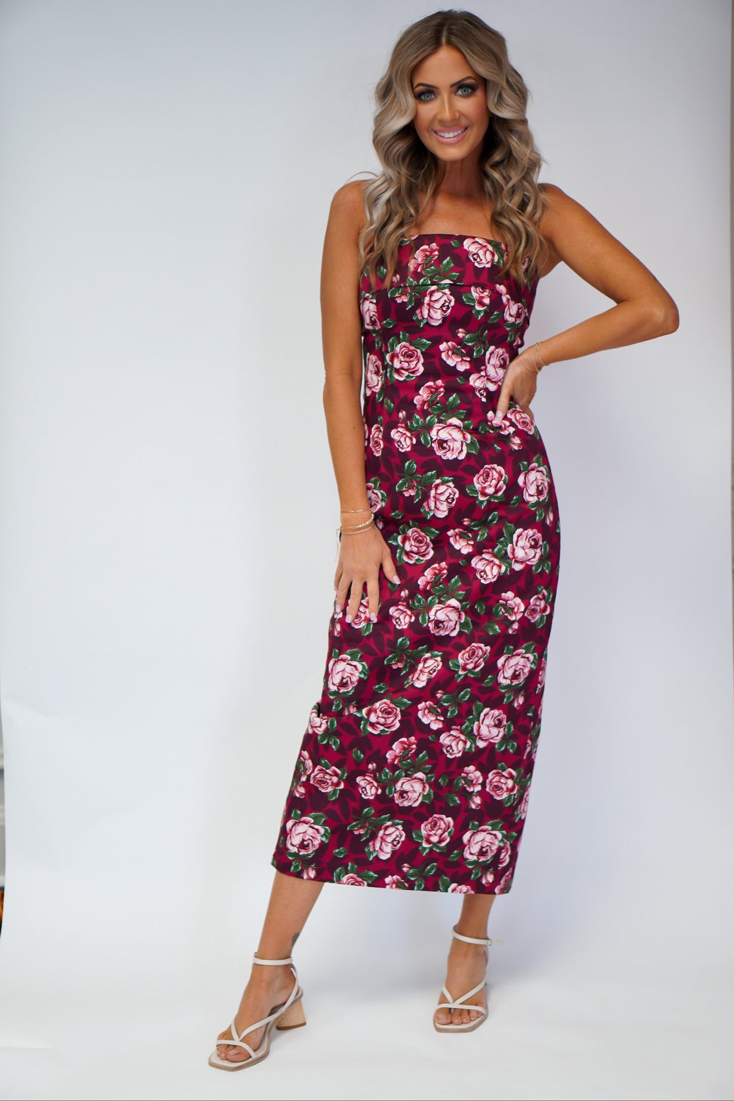 girl wearing tube dress with floral detail maxi style with hand on hip