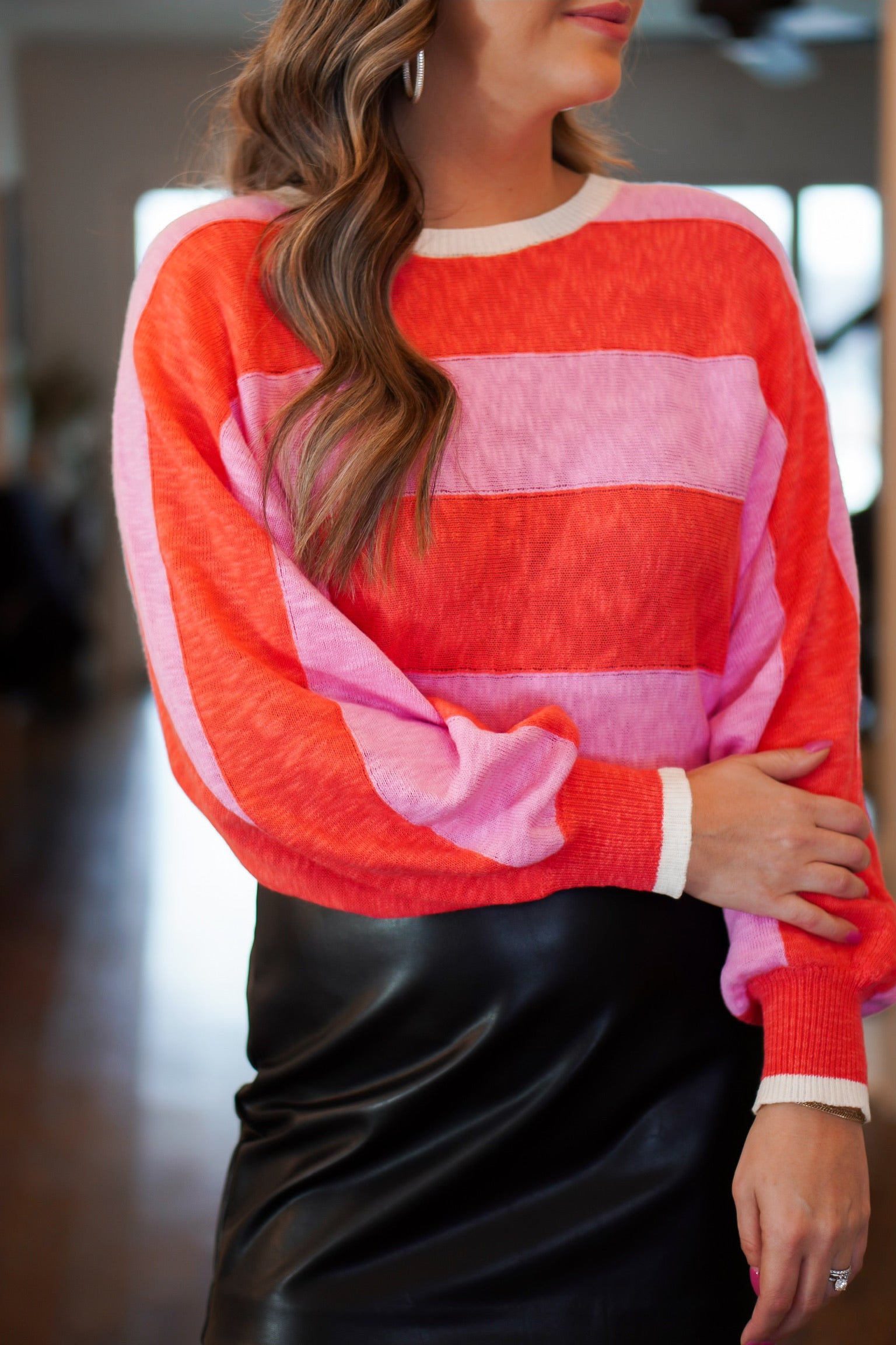 a lightweight red and pink sweater with white trim detail 