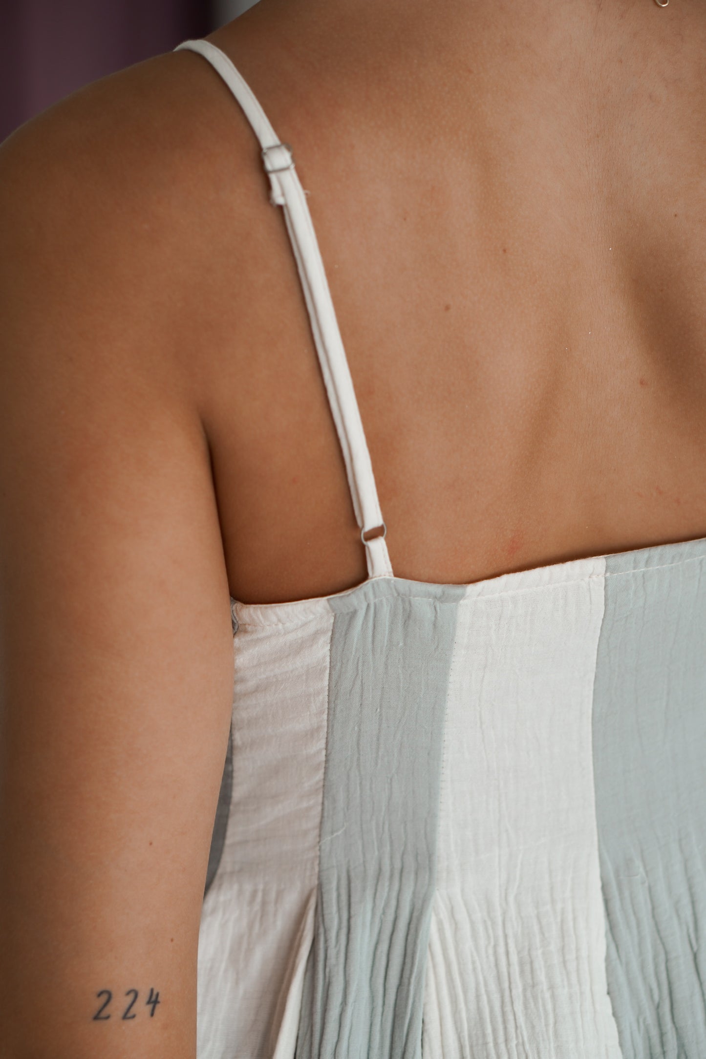 Showing the adjustable straps on the long dress