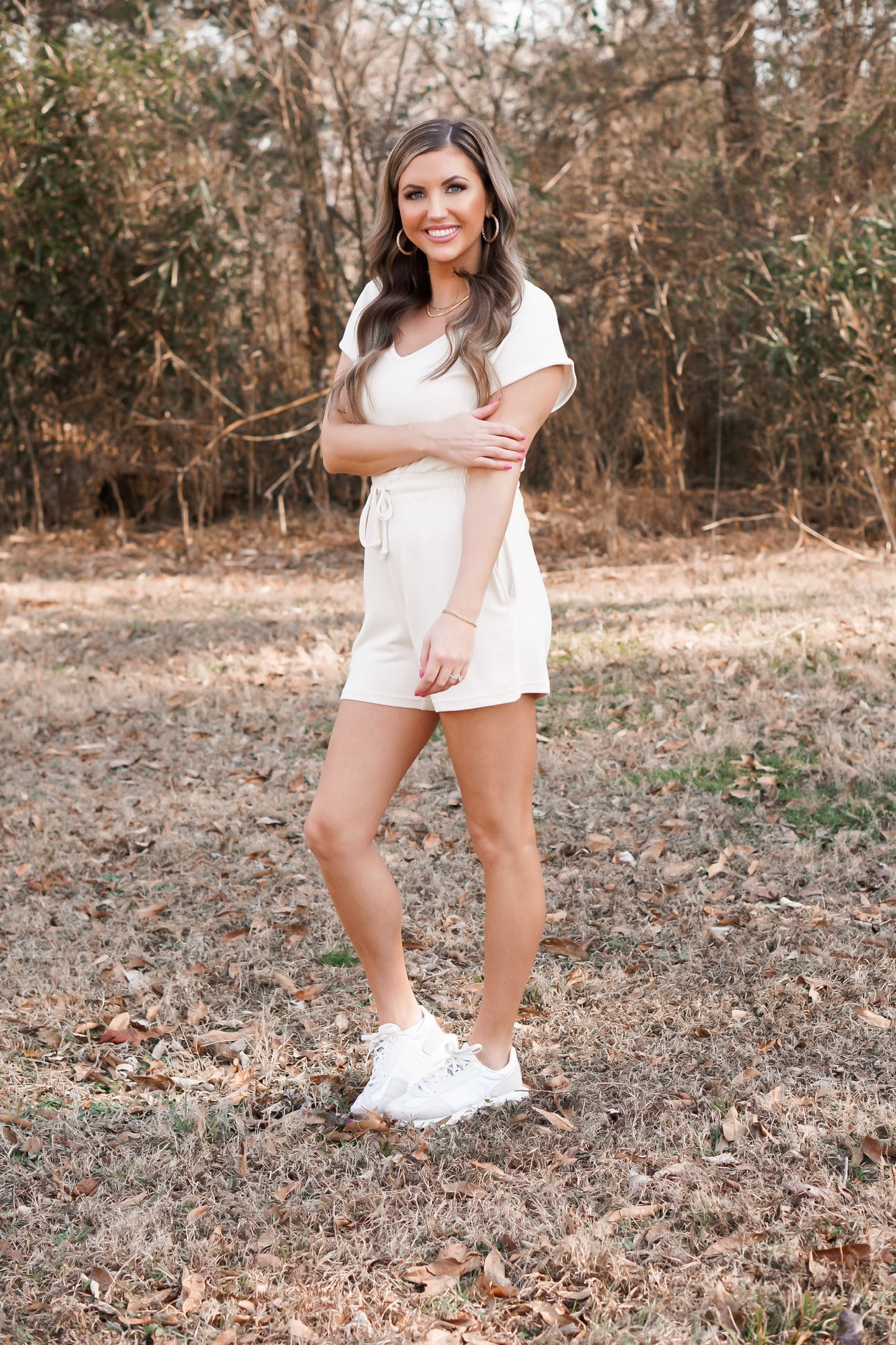 girl wearing  a cream cozy romper with v-neck